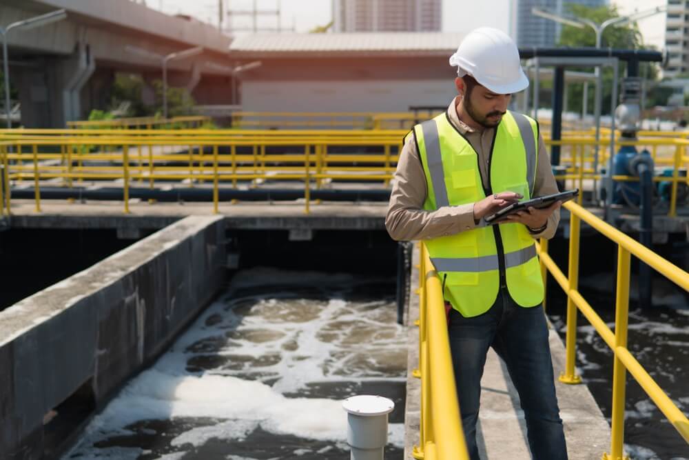 An engineer performing environmental consulting services at a wastewater treatment plant.